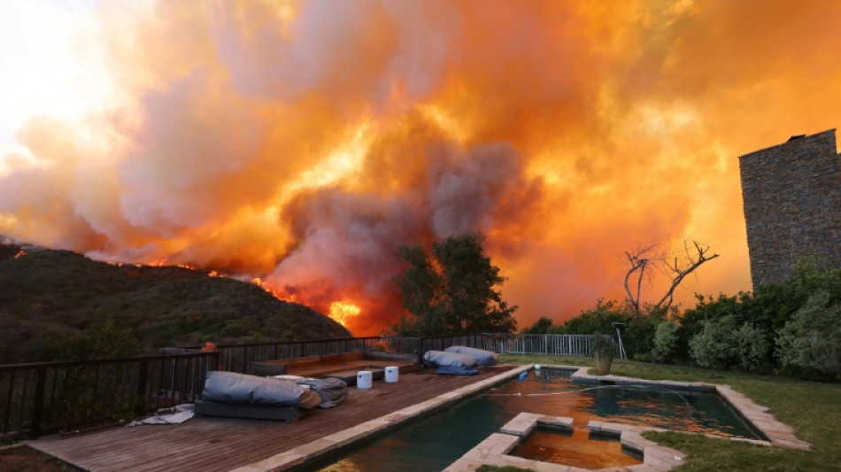 Wildfire sparks panicked evacuations in Los Angeles suburb