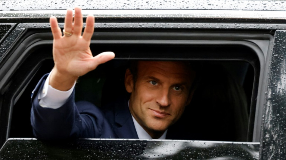Macron meets France opposition, retains PM after poll blow